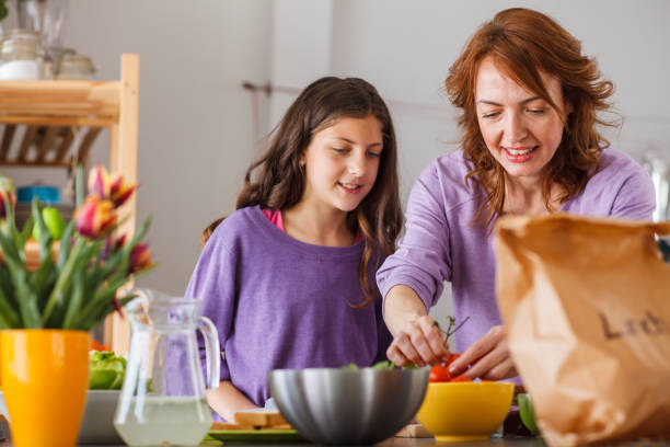 istock Picking fresh tomatos to add to a take-away sandwich 1212917348