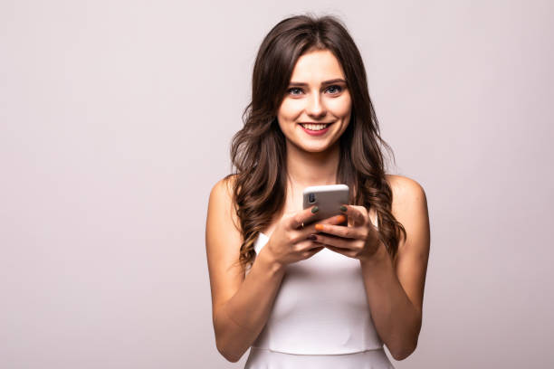 istock Young woman texting on her mobile phone isolated over a white background 1212920442