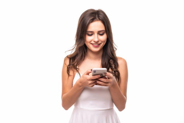 istock Young woman sending a sms on cell phone on white background 1212920536