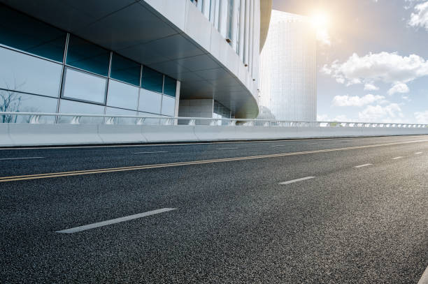 istock Divided highway passing through city buildings, blue nostalgia high contrast 1212921093