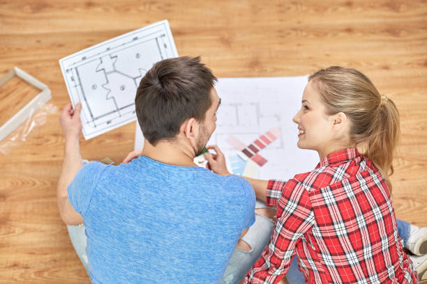 istock smiling couple looking at color samples at home 1212921359