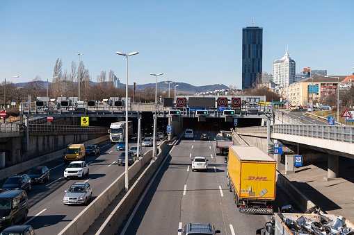Vienna, Austria - March 5, 2020: Traffic on the A22 motorway in Vienna on a sunny day in spring. This is one of Vienna's most important transit routes along the river Danube.