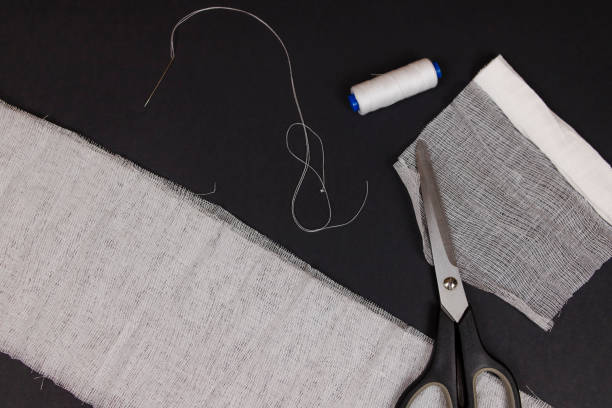 Do-it-yourself medical mask flat lay. Sew your own mask using gauze, scissors and needle with thread. Infection protection concept. Coronavirus COVID-19 cause shortage of medical masks in pharmacies.