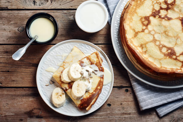 istock Thin pancakes, crepes with bananas and condensed milk. 1212924303