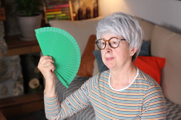istock Uncomfortable senior woman during heatwave 1212924425