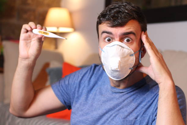 istock Worried sick man with fever 1212924526