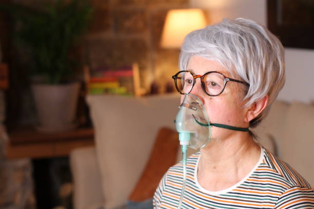 istock Senior woman using a respirator at home 1212924548
