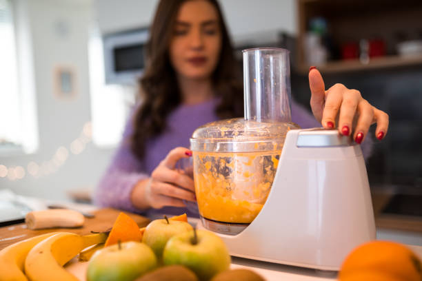 istock Woman in kitchen using electric mixer 1212925578
