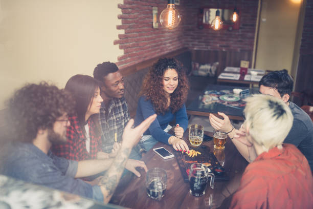 istock Group of friends drinking beer in the pub 1212925888