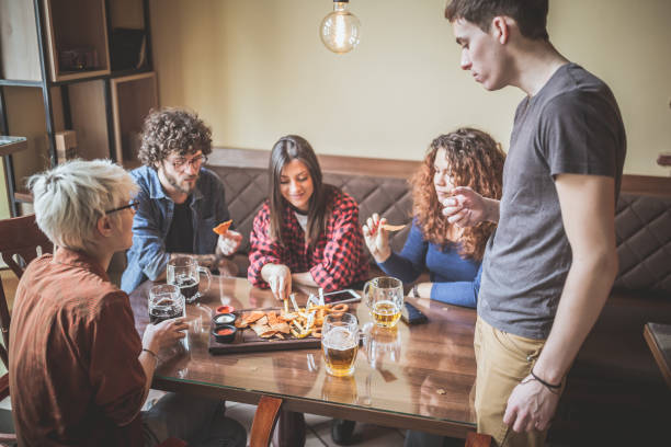 istock Group of friends drinking beer in the pub 1212925903