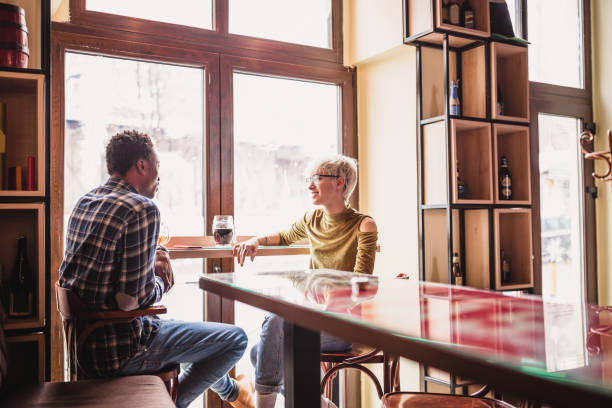 istock Young couple, talking in a pub 1212925975
