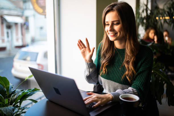 istock Young pretty woman making video call in cafe 1212927120