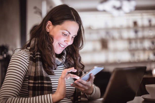 istock Woman using mobile phone in the restaurant 1212927301
