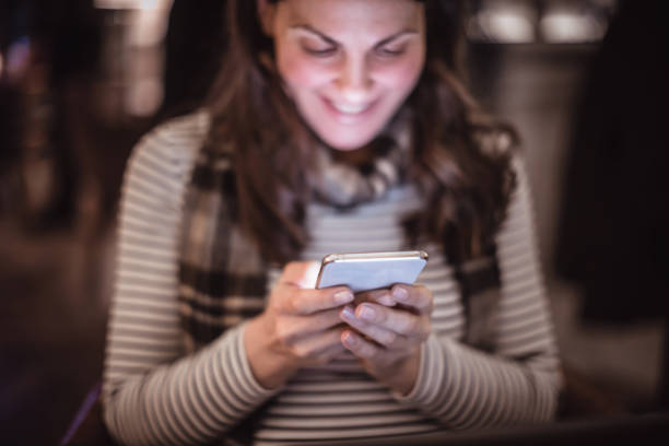 istock Woman using mobile phone in the restaurant 1212927306