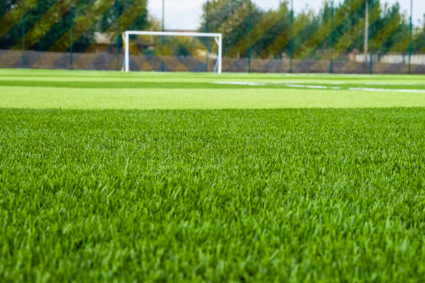 istock Artificial green grass on the football field 1212928827