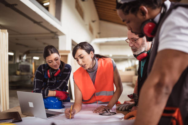 istock Female engineer directing her colleagues 1212929894