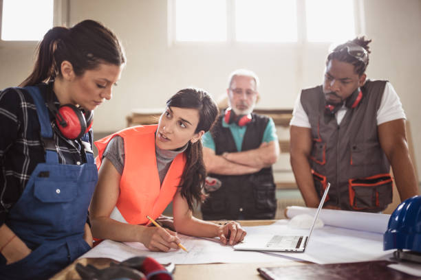 istock Female engineer directing her colleagues 1212929898