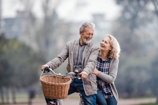 istock Happy senior couple talking while cycling in nature. 1212929902