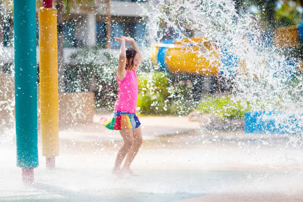 istock Child playing under tip bucket in water park. 1212930165
