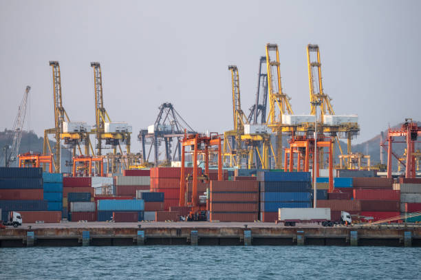istock unloading containers of cargo ship. Logistic business concept. 1212931041