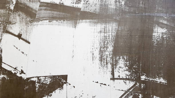 istock Weathered and aged concrete wall with paint, mostly peeled from black and white with vignetting. Shades of gray and white. Great modern, textured background. Abstract old background 1212931390