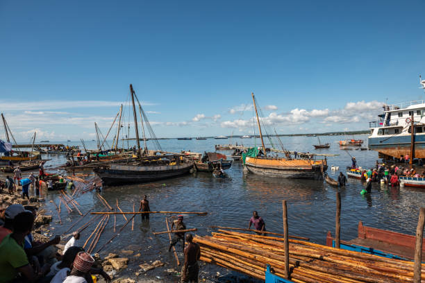 Behold the serenity of a traditional boat gently moored on the tranquil surface of a calm sea.
