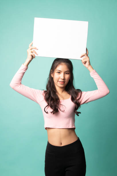 istock Young Asian woman with white blank sign. 1212932132