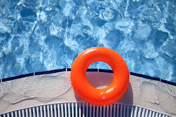 istock floating orange ring on edge of swimpool 121293779