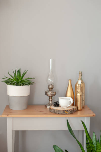 istock Table with flower, kerosene lamp, bottles 1212938406