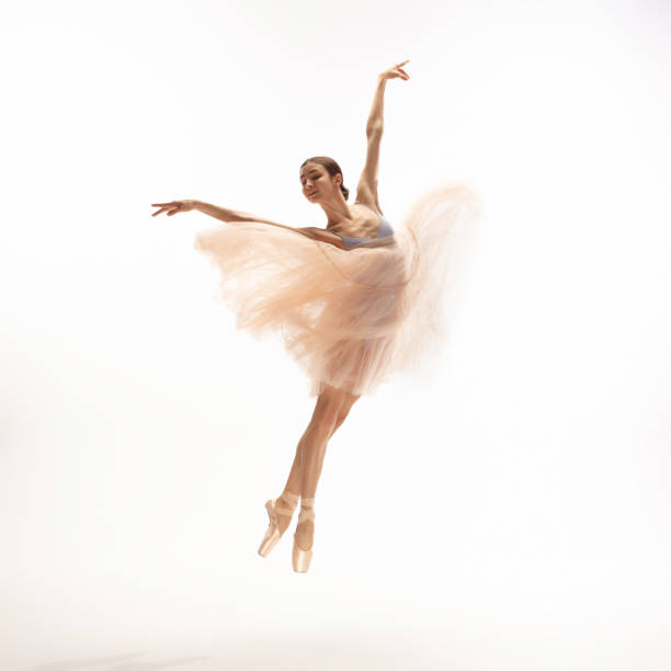 istock Young graceful tender ballerina on white studio background 1212938542