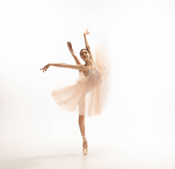istock Young graceful tender ballerina on white studio background 1212938544