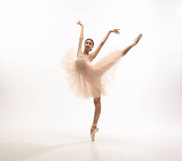 istock Young graceful tender ballerina on white studio background 1212938549