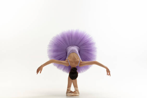istock Young graceful tender ballerina on white studio background 1212938591