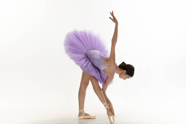 istock Young graceful tender ballerina on white studio background 1212938602
