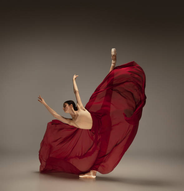 istock Young graceful tender ballerina on grey studio background 1212939187