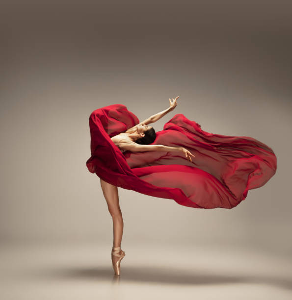 istock Young graceful tender ballerina on grey studio background 1212939237