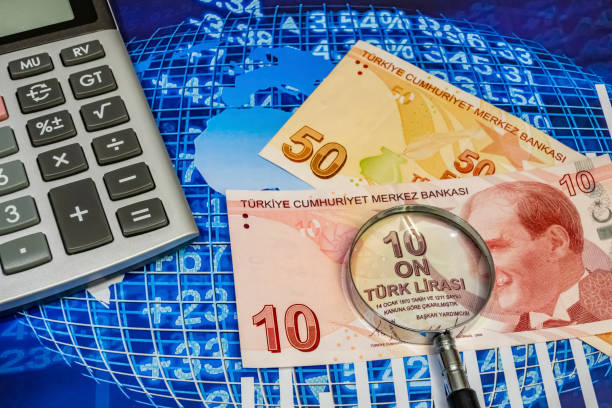istock close up turkish lira banknotes with calculator and magnifier on background 1212942408