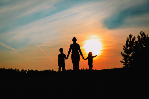 istock father with son and daughter walk at sunset 1212947610