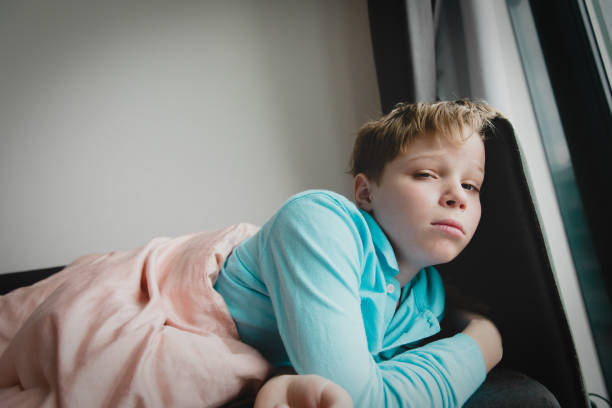 istock Sick child with infection or virus at home, self isolation 1212948467