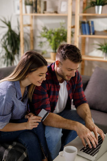 istock Young affectionate couple shopping online using laptop 1212949175