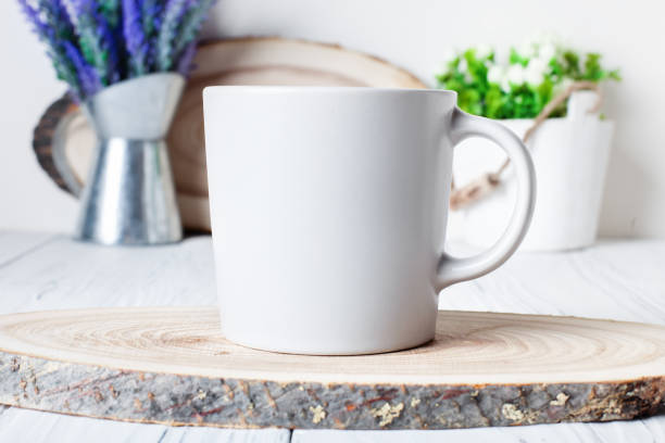 istock White mug on a background of flowers . Mock up. Template Space for creative artwork. Lettering text product promotion branding. 1212949190