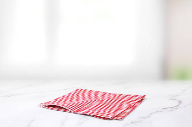 istock Red checkered picnic cloth on wooden table natural blurred background,product display. 1212949497