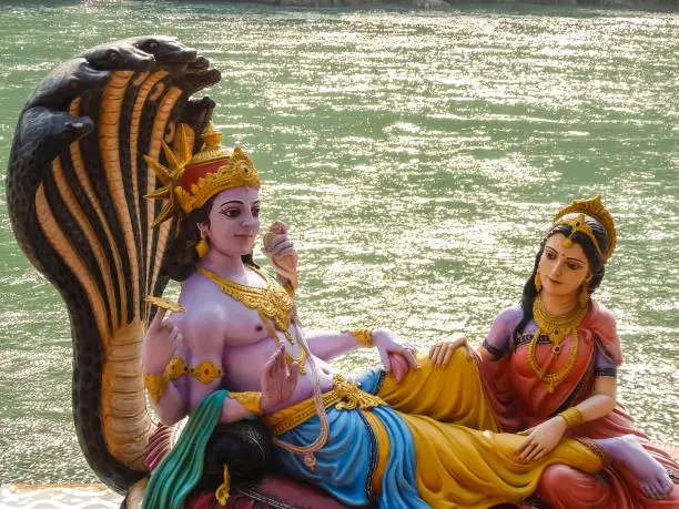 Photo of Beautiful statues of Lord Vishnu and Lakshmi at the Ganga riverbank in Rishikesh.