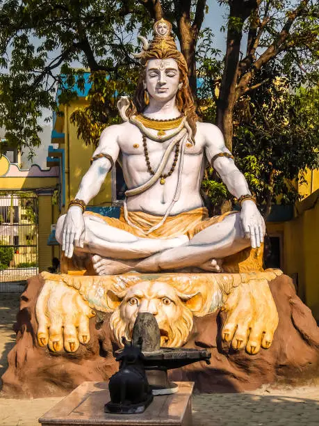 Rishikesh, India. Statue of Shiva sitting in meditation on the riverbank of Ganga in Rishikesh.