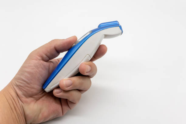 istock Man hand holding digital thermometer on a white background 1212952182