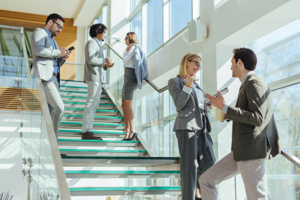 istock Two business people discussing report on stairs 1212952336
