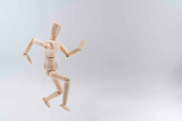 istock Wooden dummy proudly presents some invisible thing, isolated on white background, copy space for your object or text 1212952623