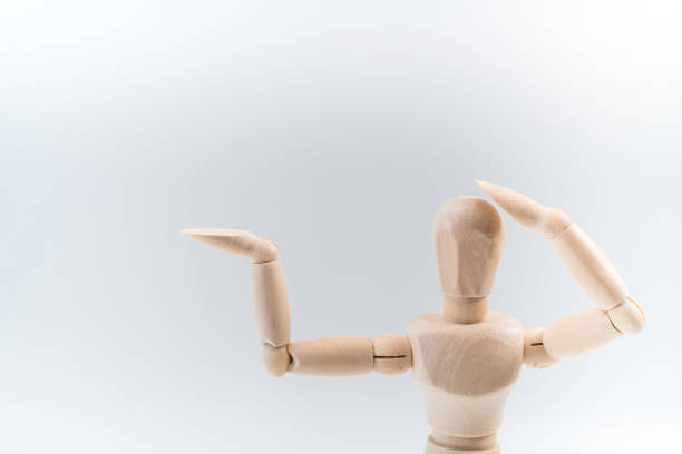 istock Wooden dummy proudly presents some invisible thing, isolated on white background, copy space for your object or text 1212953776