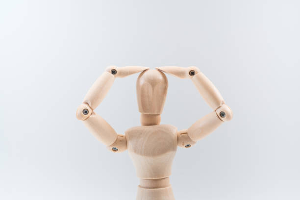 istock Wooden dummy proudly presents some invisible thing, isolated on white background, copy space for your object or text 1212954409
