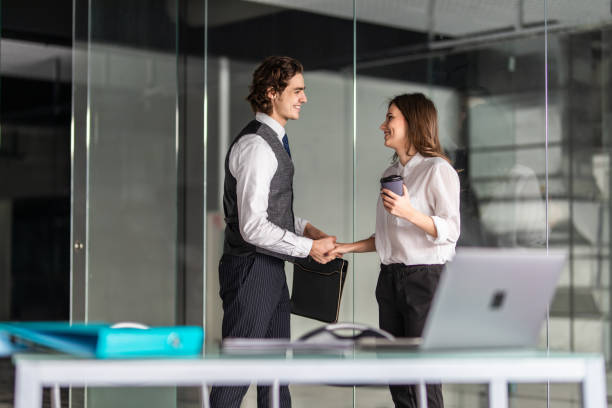 istock Working together on project. Two young business colleagues working in office 1212956239